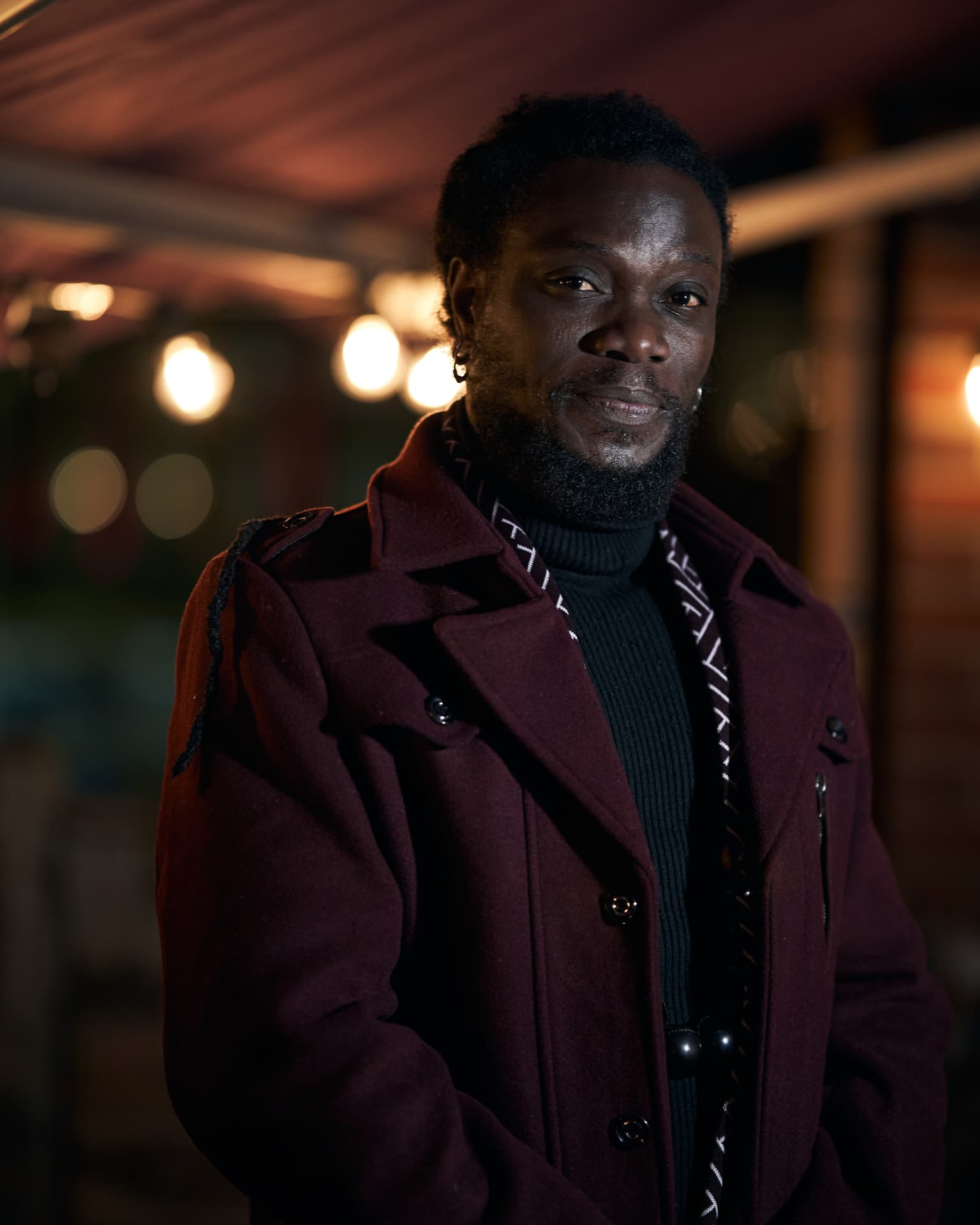 Raymond, licensed massage therapist and owner of Orion Massage Clinic in Halmstad, portrait in a burgundy coat